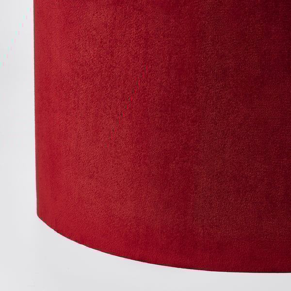 Red velvet-like texture lamp shade close-up. Soft, rich, high-quality interior detail.