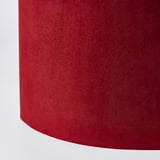 Red velvet-like texture lamp shade close-up. Soft, rich, high-quality interior detail.