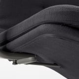 Close-up of office chairs padded seat and armrest. Shows quality fabric and stitching.