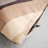 Close-up of a zipper on a cushion cover, showcasing its quality and design.