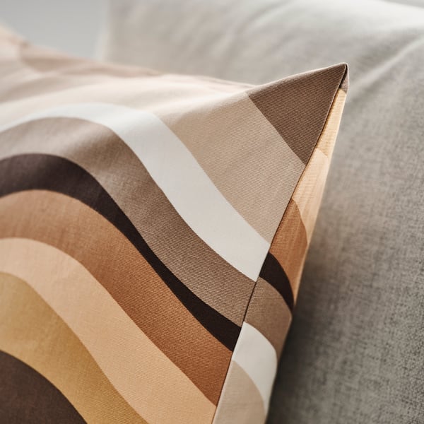 Striped cushion cover with warm tones, showing quality stitching and fabric texture.