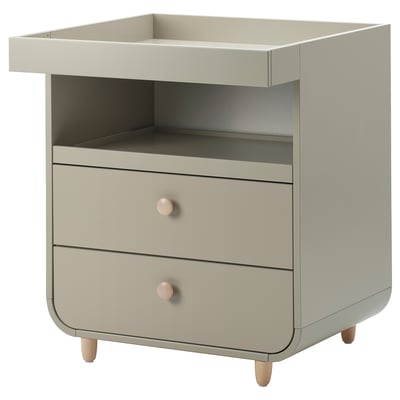 A beige MYLLRA changing table with two drawers and wooden knobs, intended to convert into a chest of drawers and shelf post baby stage.