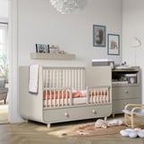 Modern nursery with MYLLRA crib, drawers, adjustable base. Includes changing table, bookshelves, toys, and cloud lamp.