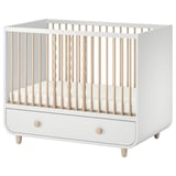 Modern white & wood baby crib with adjustable mattress height, one removable side, and under-drawer storage.