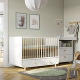 Cozy nursery with MYLLRA white crib, green wall art, soft rug, mobile, and changing table. Crib is large compared to other items.