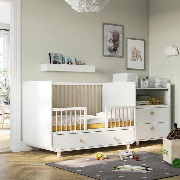 Childs room with MYLLRA cot & storage, decorated with photos & toys.