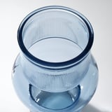 Glass vase, recycled with unique bubbled texture, vibrant blue hue. Seen from above, smooth interior, clean lines.