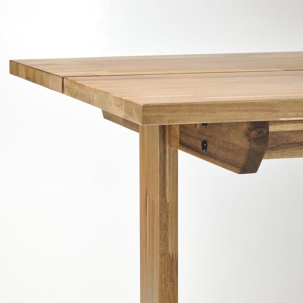 Wooden table corner, natural finish, sturdy construction.
