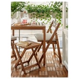 Wooden balcony set with light cushions, plants, and books.