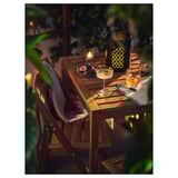 Nammaro set: outdoor table & chairs with snacks, candles, & blanket for cozy evenings.