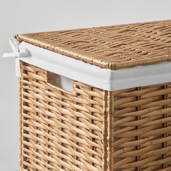 Hand-woven wicker laundry basket with white liner. Natural, durable, and stylish design.