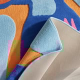 Vibrant rug with rubber backing, preventing slips and drafts. Toucan motif, soft for play.