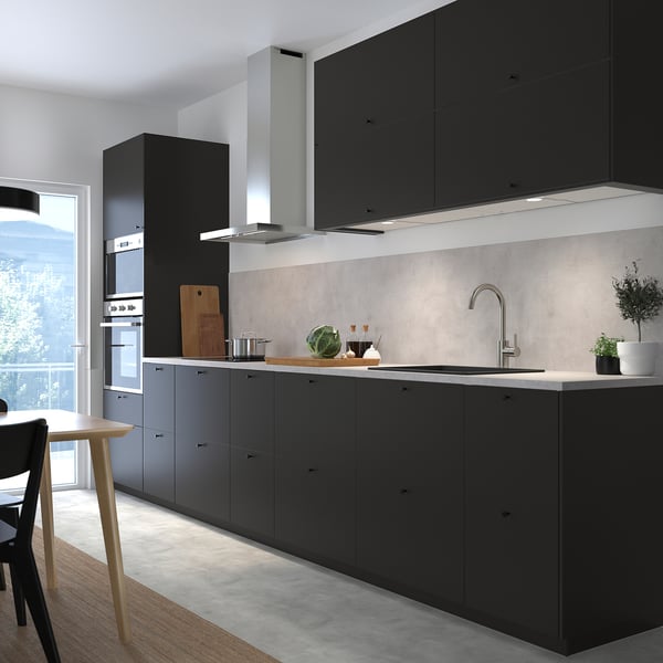 Modern kitchen black NICKEBO cabinets, sleek appliances, and a large window.