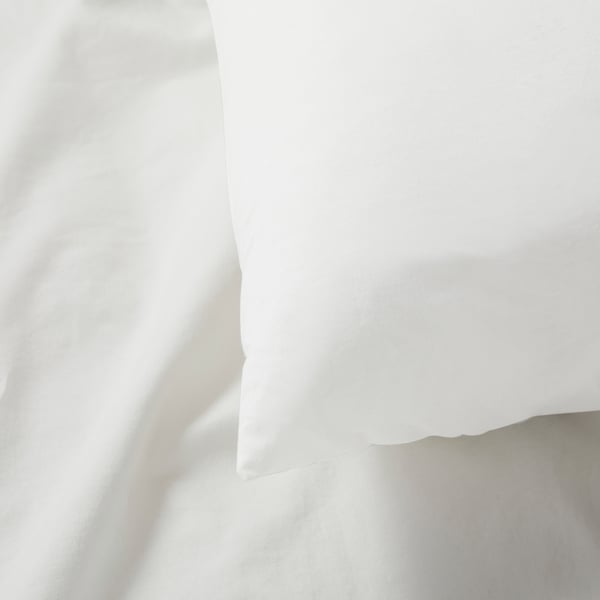 Close-up of crisp, white cotton pillowcase, smooth texture, natural weave, high-quality appearance.