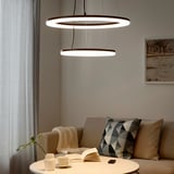 Modern living room with NORAFORS lamp, couch, and coffee table.