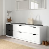 Modern white NORDLI chest with six black-handled drawers, holding a woven bag, below a mirror.