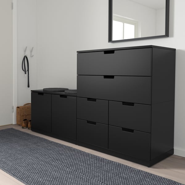 Black NORDLI drawers in entryway, 3+2 units on rug, coat rack nearby. Or black NORDLI drawers, 5 drawers in entryway, coat rack, gray rug.