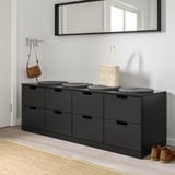 Black NORDLI chest with cushions, bag, and mirror.