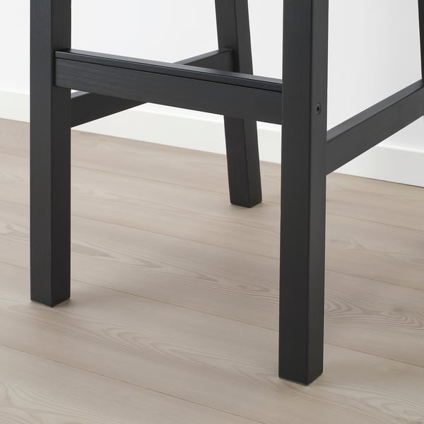 Black bar stool with wooden legs, showing sturdy construction and curved seat, designed for comfort and durability.