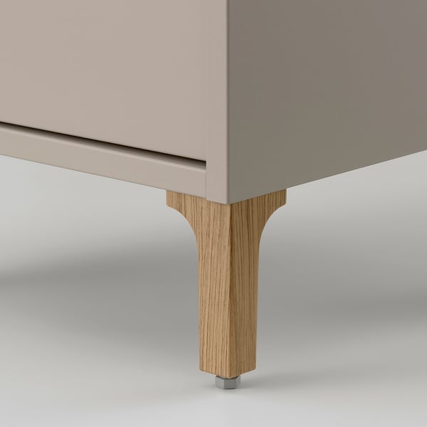 Close-up of NORSÄLVEN cabinets sturdy, angled wooden leg with metal bolt fixing. High-quality craftsmanship.