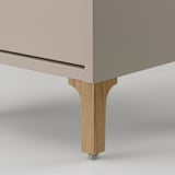 Close-up of NORSÄLVEN cabinets sturdy, angled wooden leg with metal bolt fixing. High-quality craftsmanship.