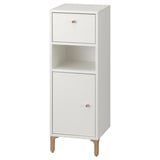 This image shows a white NORSÄLVEN bathroom cabinet with a drawer, door, and shelves for storage. It has wooden legs and a clean, minimalist design.