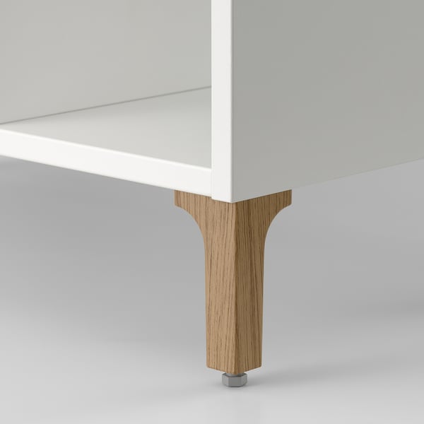 A modern white bathroom cabinet with sturdy wooden legs, designed for compact storage, ensuring stability and elegance.