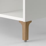 A modern white bathroom cabinet with sturdy wooden legs, designed for compact storage, ensuring stability and elegance.