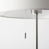 Modern floor lamp with adjustable height, featuring sleek metal design and white textile shade, ensuring durability and stylish lighting.