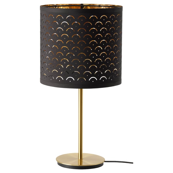 NYMÖ lamp, gold and black. Perforated shade casts light pattern. Round base, sleek design.