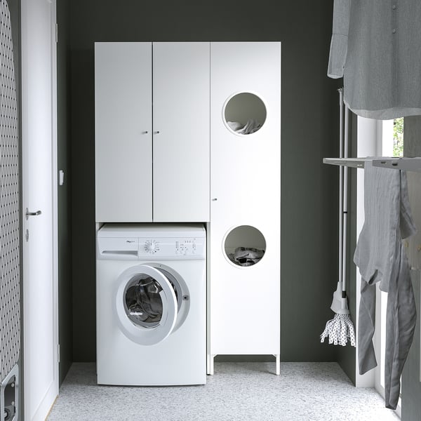 Small space laundry with white NYSJÖN storage cabinet and washing machine. Mounted above washer, saving floor space. Cabinet conceals dirty clothes.