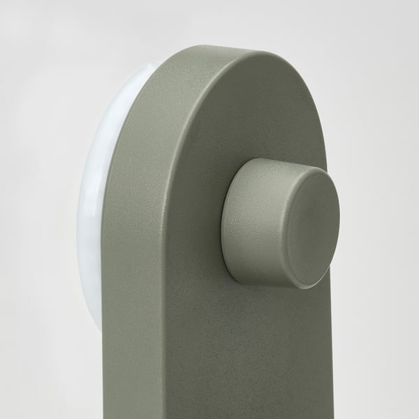 A sleek, modern wall organizer with a smooth, grey-green finish and rounded edges. It uses concealed suction cups for secure, drill-free mounting.