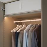 Modern closet with led lights showcasing colorful clothes.