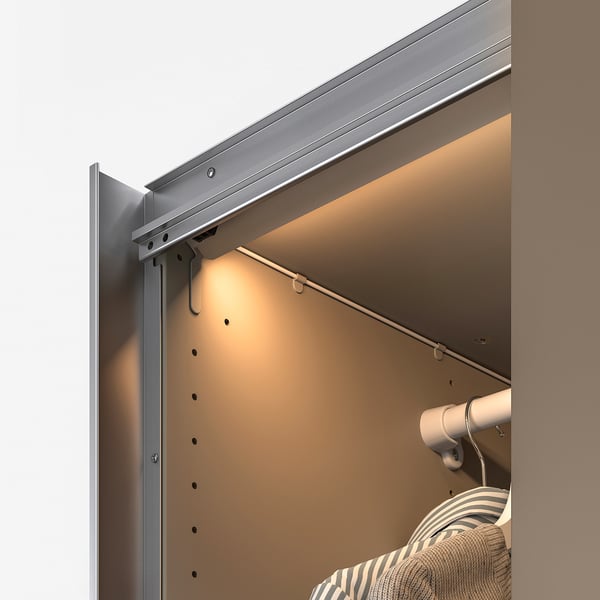 A modern wardrobe light with sensor automatically turns on and off, illuminating the interior for easy clothes selection.