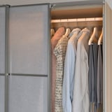 A modern wardrobe with led lights that automatically turn on when opened, illuminating clothes for easy selection.