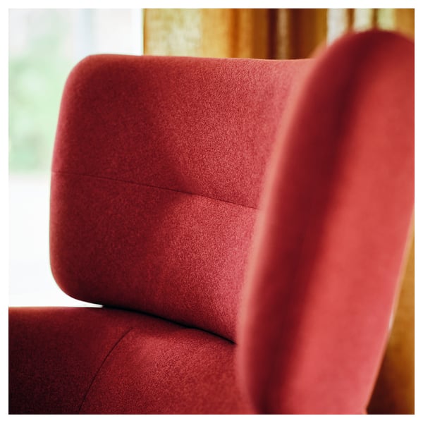 Close-up of a red upholstered chairs cushioned backrest, showcasing soft, inviting texture and high-quality fabric.