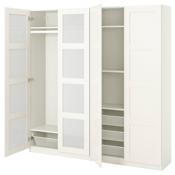 A white ikea PAX wardrobe with mirrored doors and open compartments revealing shelves and a mesh drawer.
