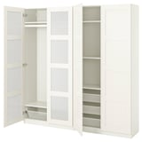 A white ikea PAX wardrobe with mirrored doors and open compartments revealing shelves and a mesh drawer.