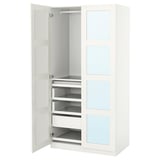 An open white PAX wardrobe with drawers and shelves.