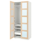 An open white PAX wardrobe with light wood accents. It glass doors, drawers, shelves, and hanging space.