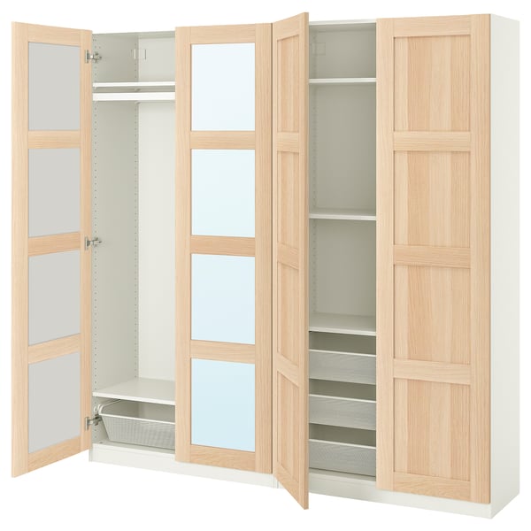 A minimalist light wood PAX wardrobe with shelves and compartments.