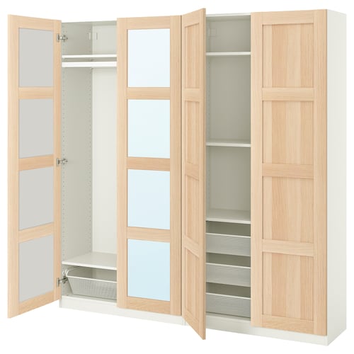 A minimalist light wood PAX wardrobe with shelves and compartments.