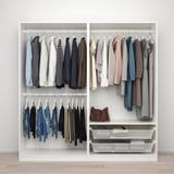 Organized closet with hanging shirts and pants, fabric baskets, and adjustable storage.