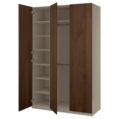 An open PAX wardrobe with dark brown wooden doors and shelves.