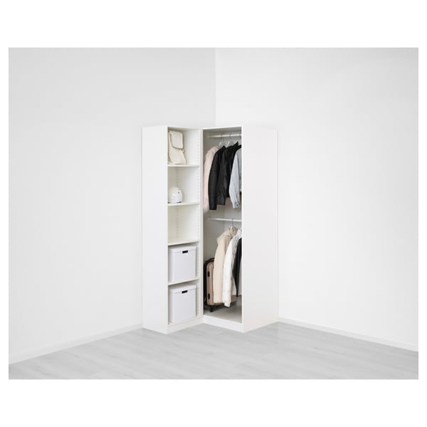 Open white corner wardrobe with clothes and storage boxes inside, showing shelving and hanging space.