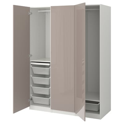 A light pink PAX wardrobe with open doors, revealing multiple storage shelves, drawers, and a hanging rod.