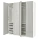 A white ikea PAX wardrobe with open doors showcasing shelves and mesh baskets.
