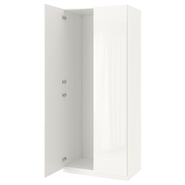 A white, tall, and rectangular ikea PAX wardrobe with one door open, revealing adjustable shelves inside.