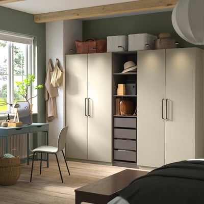 Modern bedroom with tall PAX wardrobe in beige for organised storage.