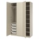 An open beige PAX wardrobe with shelves and mesh baskets.